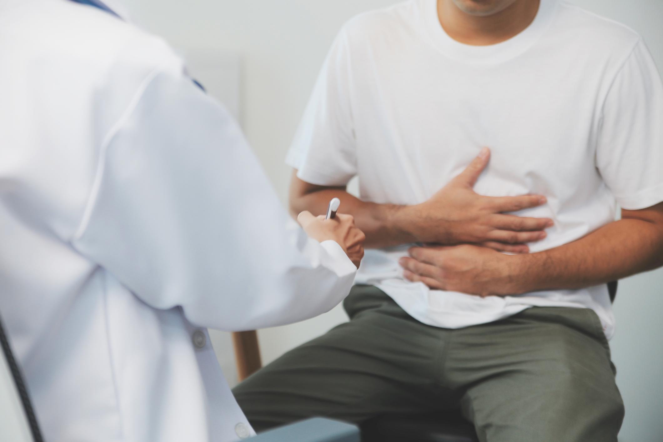 Hernia Surgery consultation with man holding stomach area